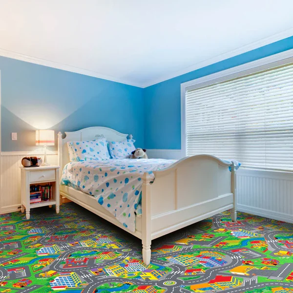 Kids' bedroom with a colorful city road map carpet.