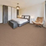 Neutral bedroom featuring tan textured carpet