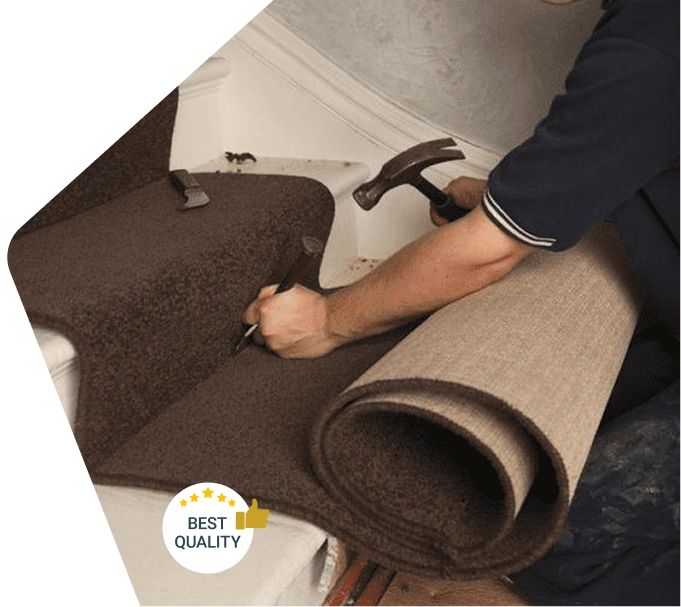 Worker installing brown carpet on staircase with hammer